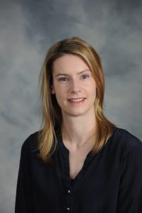 Portrait of Courtney Ward, Associate Professor of Economics. 