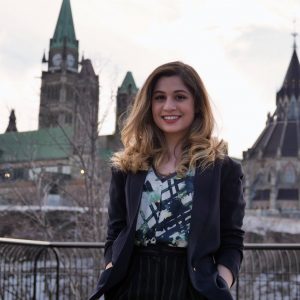 Donya Ashnaei stands in front of the parliament building in Ottawa.