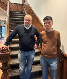 Picture taken in the Max Gluskin House stairwell. Professor Ettore Damiano, Chair of the Department of Economics, stands with PhD Candidate Guangbin Hong. 
