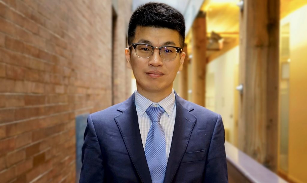 Portrait of Guangbin Jeremy Hong in the foyer of Max Gluskin House, Department of Economics HQ