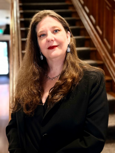 Portrait of Professor Michelle Alexopoulos on the staircase of Max Gluskin House, Dept of Economics HQ 