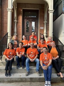 Department Chair, Professor Ettore Damiano, joins Department of Economics staff on the steps leading into Max Gluskin House.