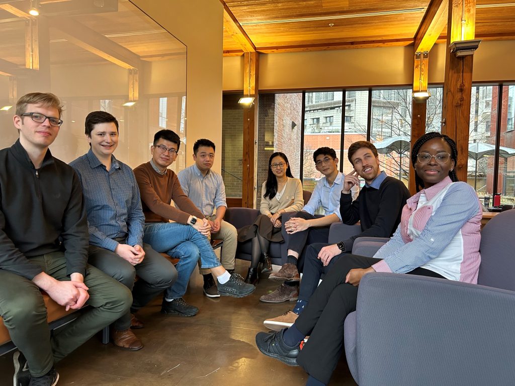 Group picture of the 2023-2024 Job Market PhD Candidates in the Department of Economics lounge.