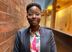 Portrait of PhD Candidate Poli Natama at Max Gluskin House, Economics HQ at the UofT. 