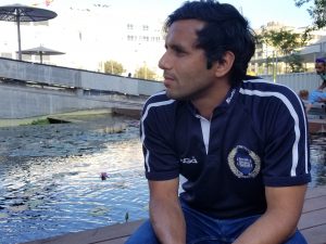 Portrait of Rahul Deb by a water feature